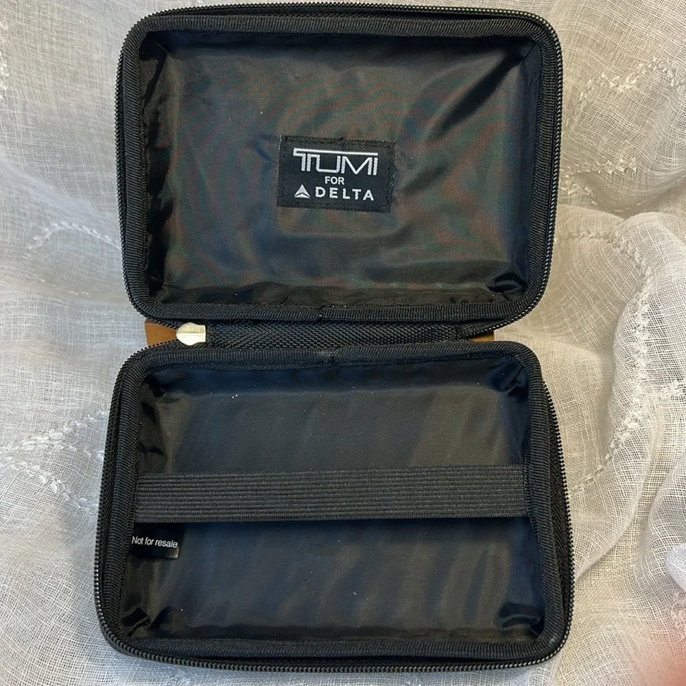 Tumi hard case luggage cosmetic bag filled with goodies for your next trip